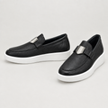 Men's black textured loafers with plain silver-tone hardware and white soles