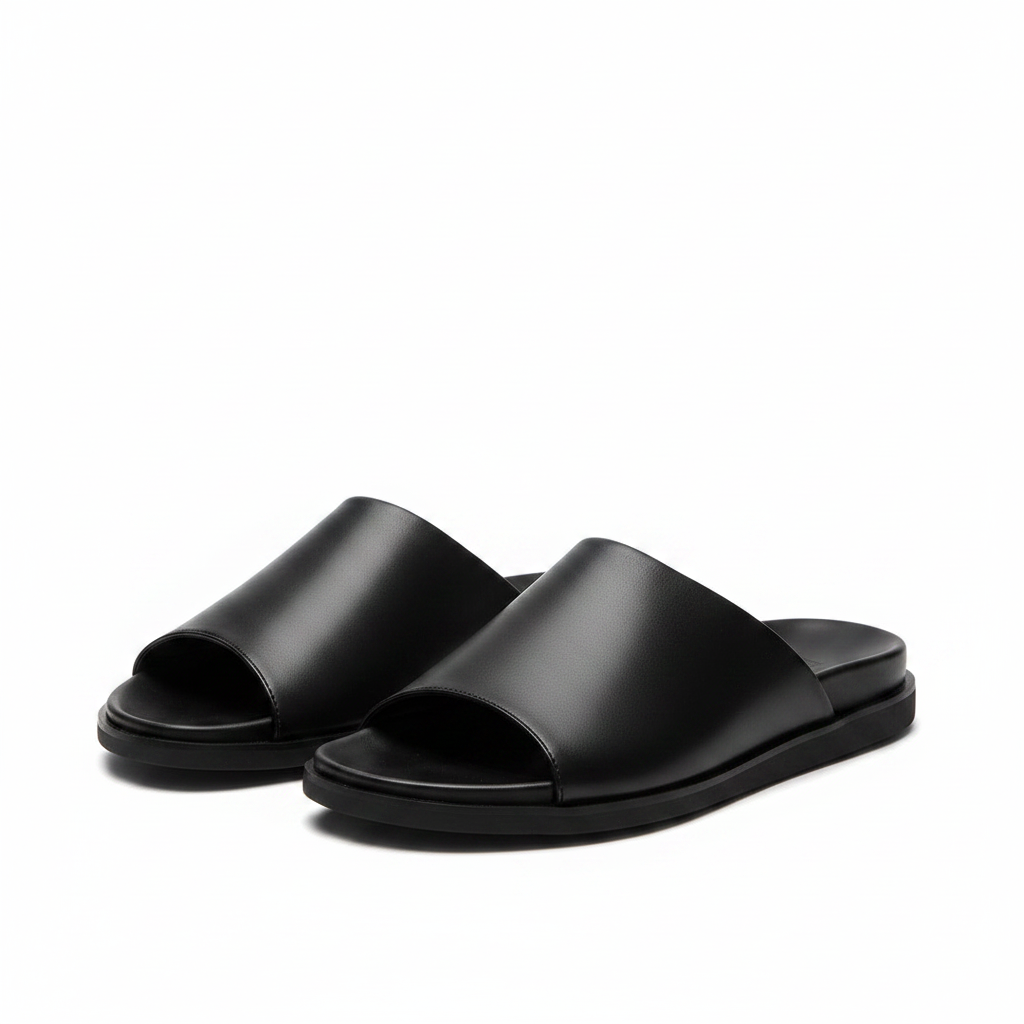 Black smooth leather minimal open-toe slide sandal ghost mannequin product shot, plain white background