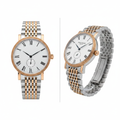Silver dress watch with rose gold coin bezel and white Roman numeral dial, front and side view on white background