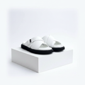 Men's white leather cross-strap slide sandals pair on white platform