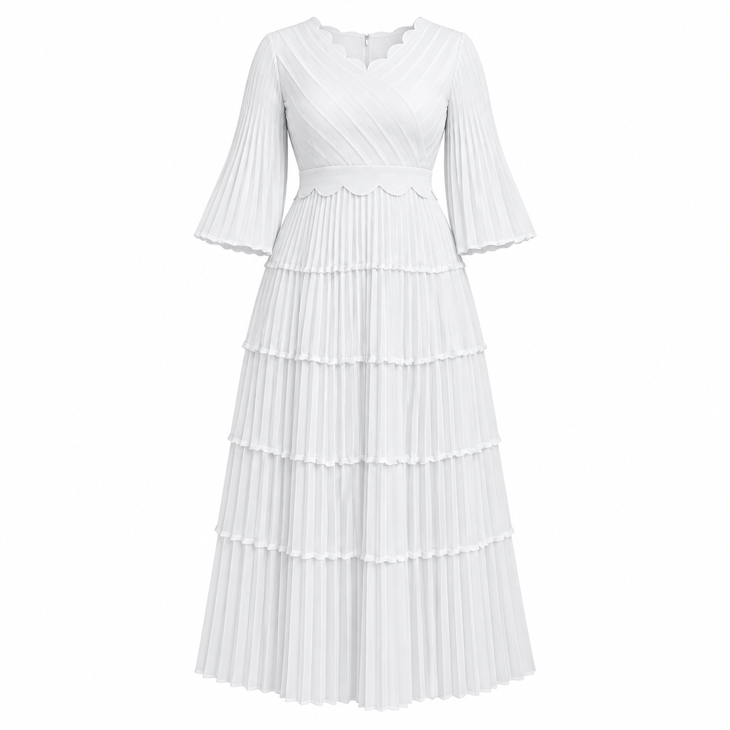 White scalloped tiered pleated dress on white background
