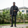 Nigerian male model wearing charcoal tactical utility hybrid denim jacket — full body street style