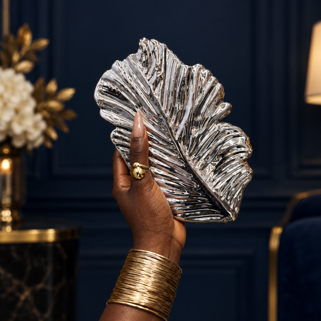 Young Nigerian woman holding silver leaf metallic clutch evening purse