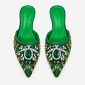 Green jeweled pointed mule pair on a clean background