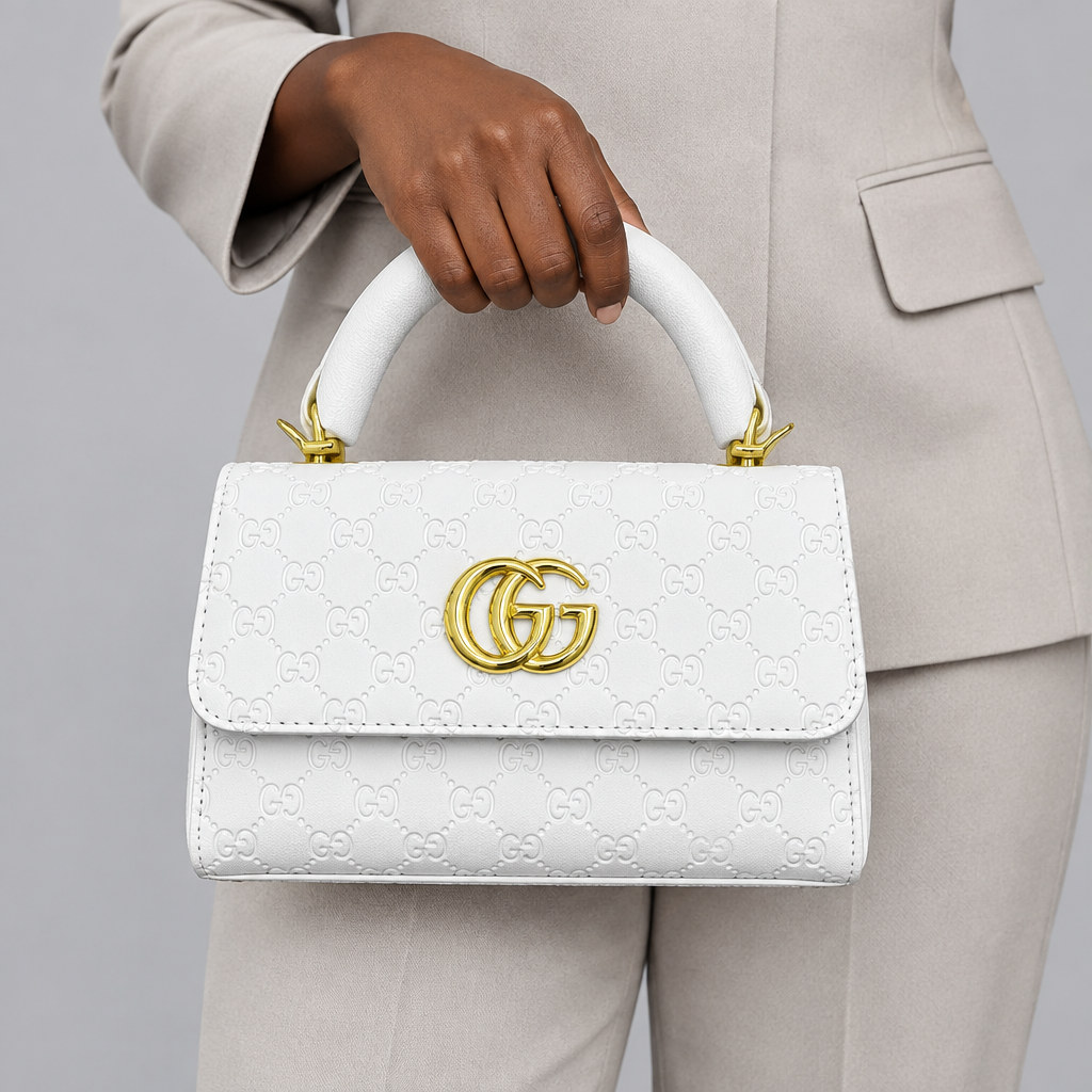 White embossed handbag held by its top handle