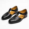 Pair of black croc-textured closed-toe sandals on white