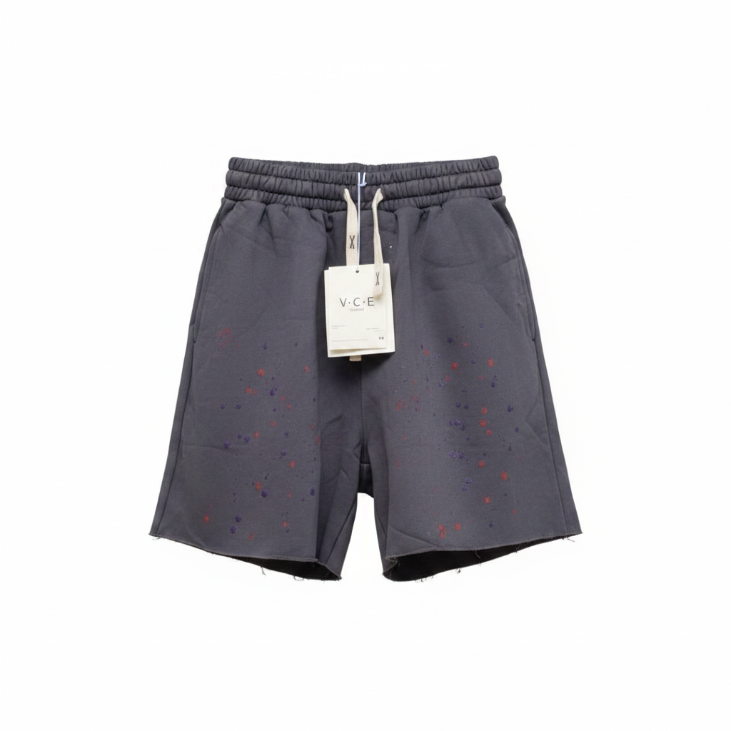 Men's charcoal paint splatter raw hem shorts — ghost mannequin front view