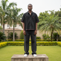 Nigerian male model full body wearing men's black red trim boxy short-sleeve shirt
