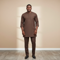 Black Nigerian model wearing the brown Senator Wear set