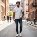 Young Nigerian male model wearing light grey polo with navy detail