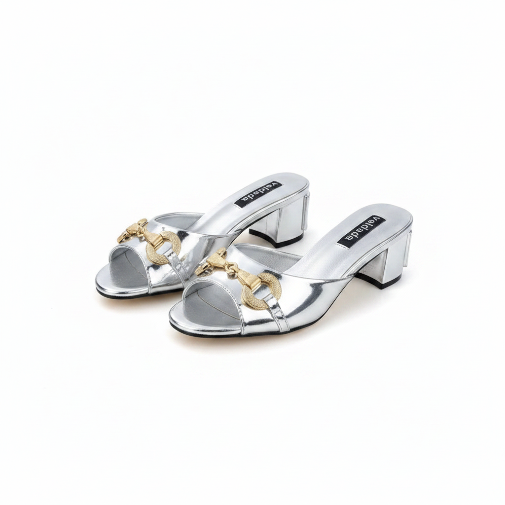Ghost mannequin pair view of silver metallic horsebit chain block heel mules