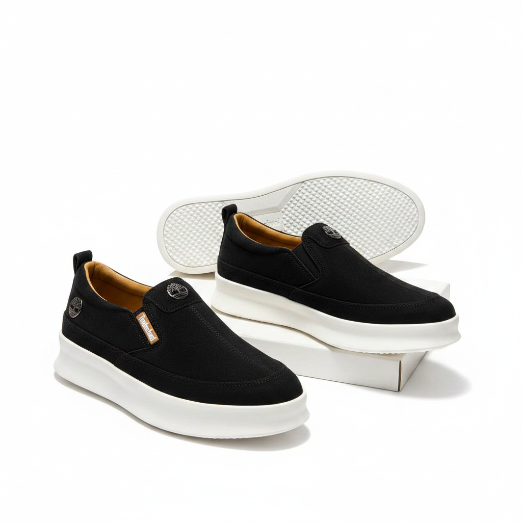 Men's black suede slip-on sneakers pair on white platform