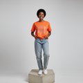 Nigerian female model front view wearing orange rhinestone medallion T-shirt