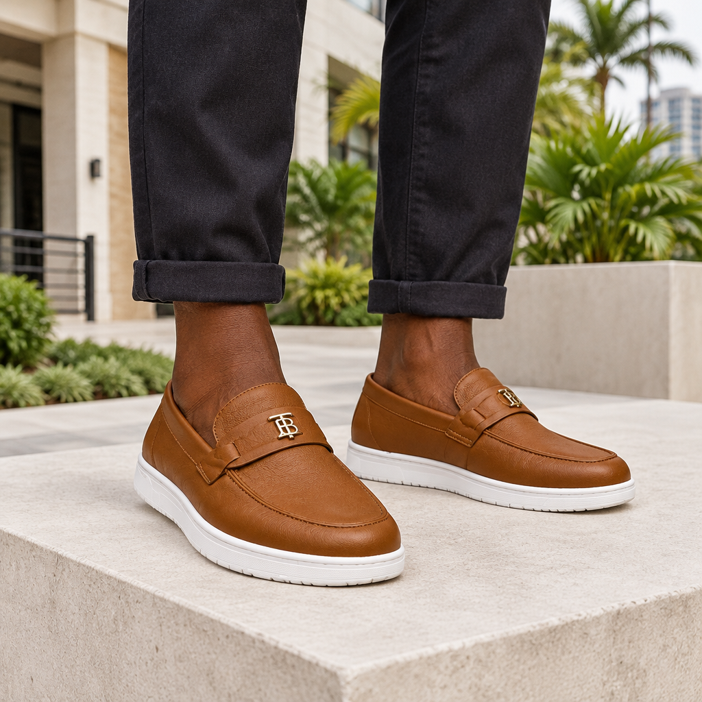 Man wearing tan leather slip-on loafers with rolled trousers