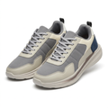 Pair of grey and cream navy-accent panelled sneakers on a white background