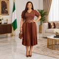 Nigerian woman wearing chestnut pleated dress
