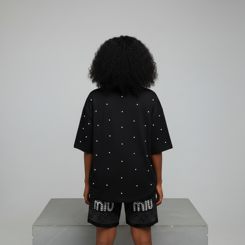Nigerian female model back view - black pearl rhinestone top and shorts set