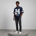 Nigerian male model wearing navy blue #24 varsity jersey shirt, front view