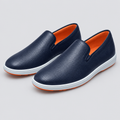 Pair of dark navy slip-on shoes with orange lining