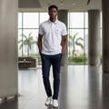 Nigerian male model wearing white polo shirt with navy and red stripe collar and cuffs