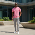Young Nigerian male model wearing a pink tipped polo shirt in a modern urban setting