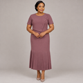 Black Nigerian woman wearing dusty mauve asymmetric button pleated midi dress