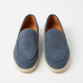 Blue ribbed slip-on loafers with cream soles and tan interiors