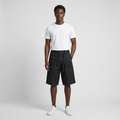 Full-body male model wearing black patch-pocket shorts