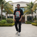 Nigerian male model wearing black skull globe illustrated graphic tee – front view