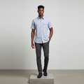 Nigerian male model wearing light blue micro-check short-sleeved shirt