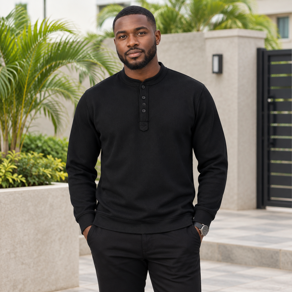 Black Nigerian adult model wearing a black textured long-sleeve pullover