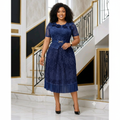 Nigerian woman wearing navy blue lace floral peplum top and pleated midi skirt set