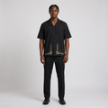 Nigerian man wearing black geometric-hem shirt and trouser set