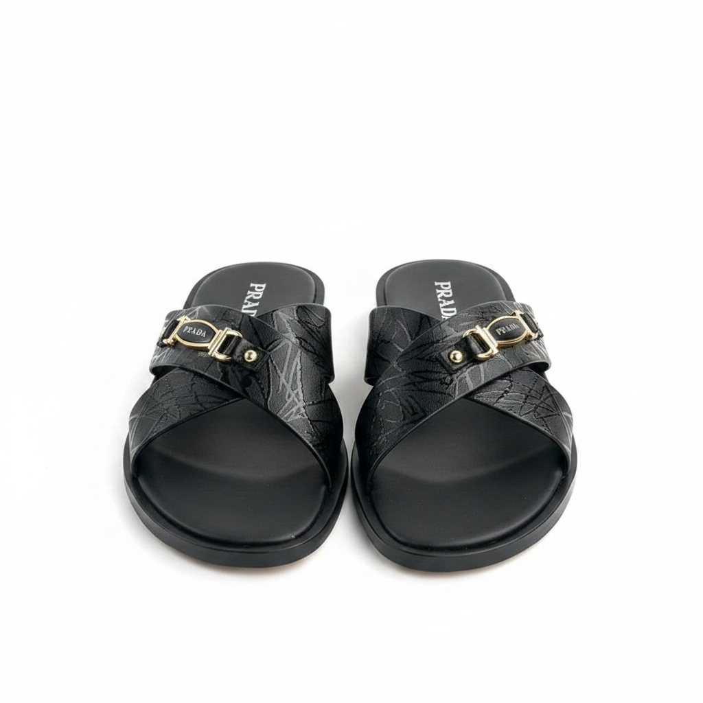 Men's black embossed quilted leather cross-strap slide sandals with gold metal plaque hardware and rivets, black cushioned footbed, ghost mannequin pair view on white background