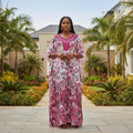 Nigerian female model wearing floral bubu kaftan dress in garden setting