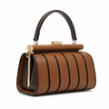 Cognac sculpted-panel top-handle bag with dark braided trim on white background
