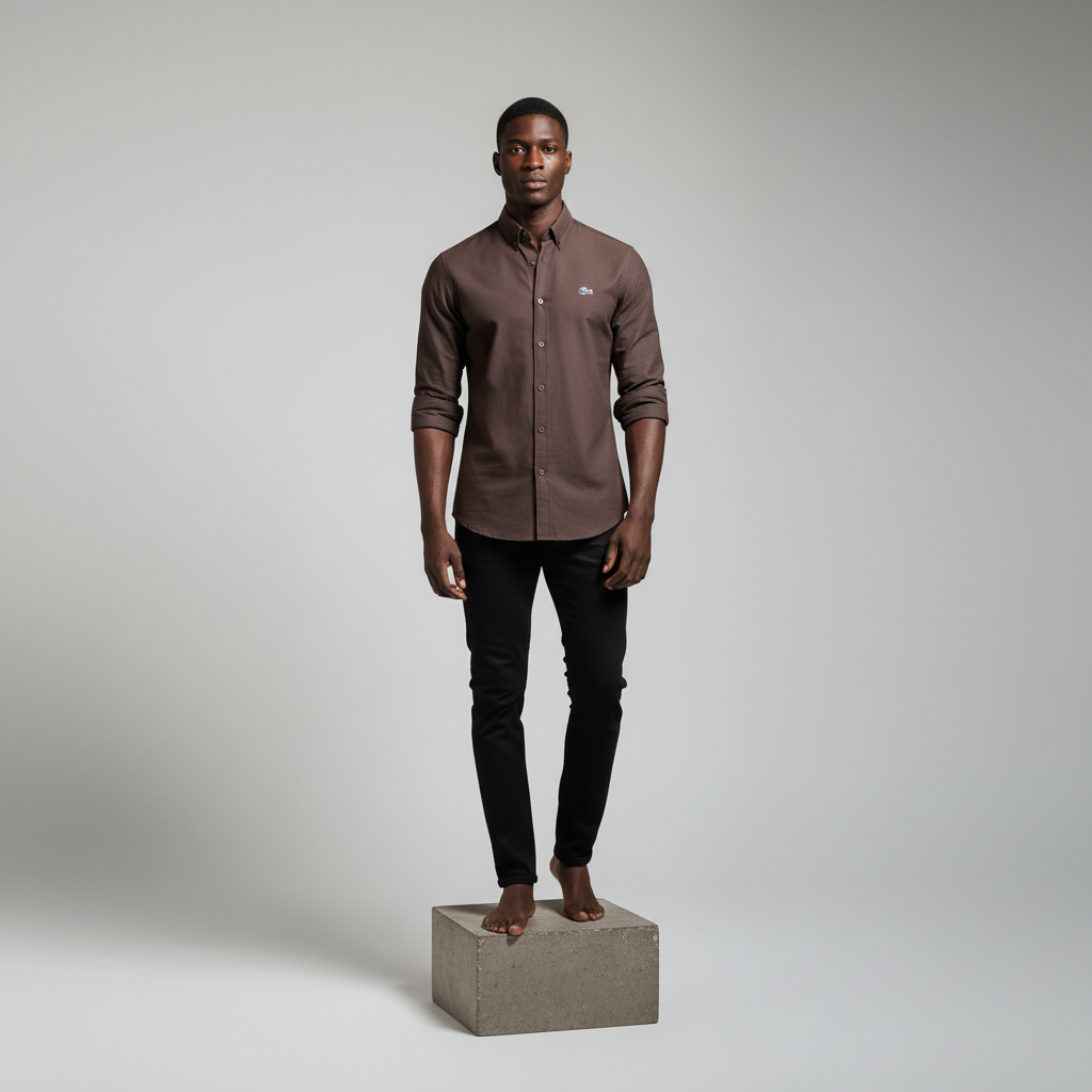 Nigerian male model wearing dark brown plain long-sleeved shirt, front view