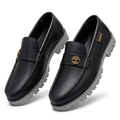 Pair of black gold-emblem loafers with contrasting grey lug soles on white