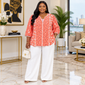 Model wearing coral floral piped blouse