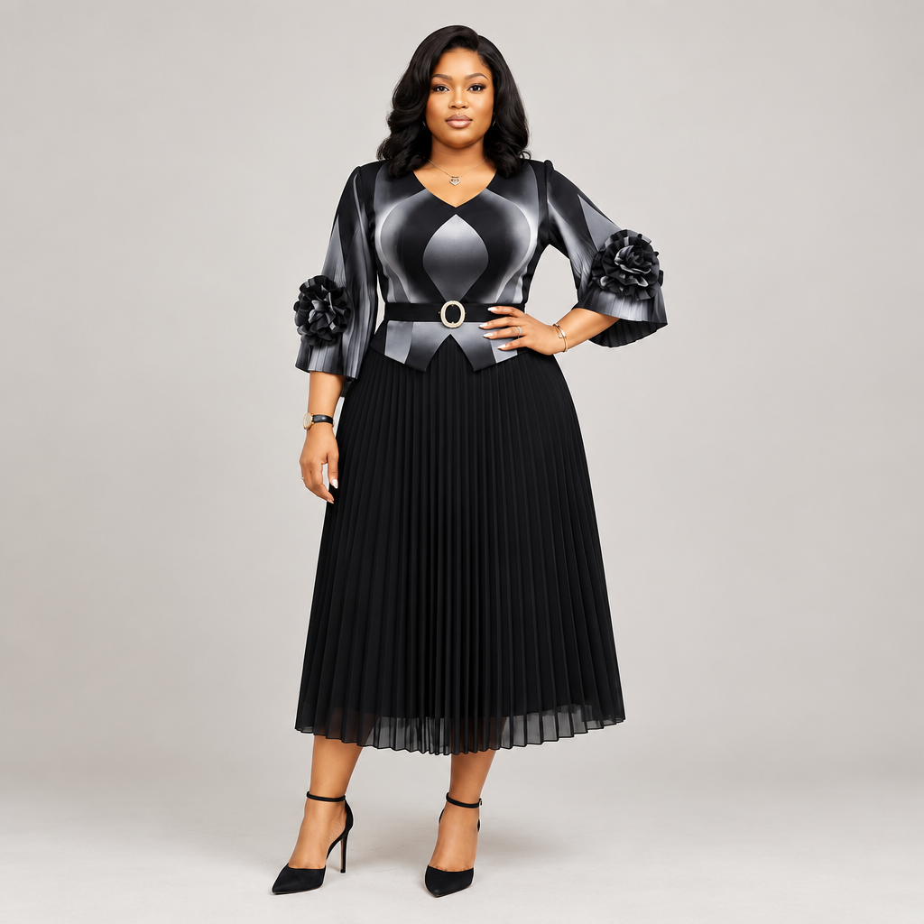 Black Nigerian model wearing a black and silver pleated gown with floral cuff accents and a belted waist