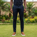 Nigerian male model wearing tan brown nubuck slip-on sneakers with white sole in garden setting