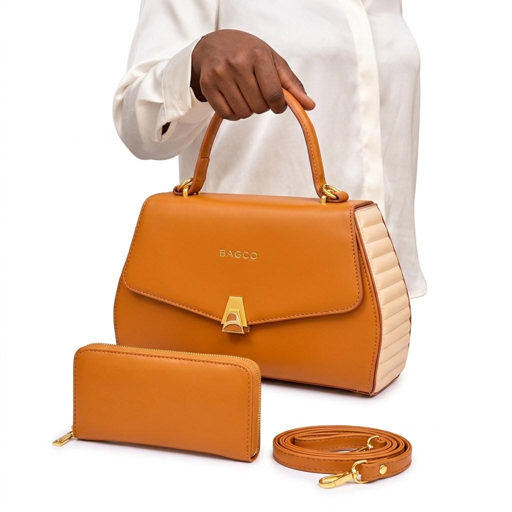 Hand holding a caramel handbag with cream ribbed sides and matching accessories