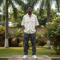 Nigerian male model wearing cream white satin utility shirt — full body street style