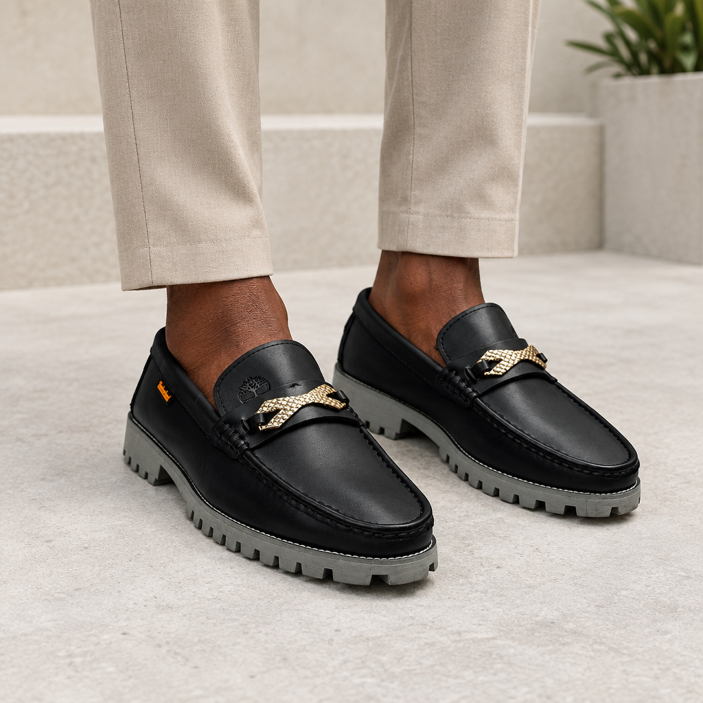 Black model wearing black men's woven-detail lug-sole loafers