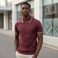 Young Nigerian male model wearing maroon zip-collar polo shirt