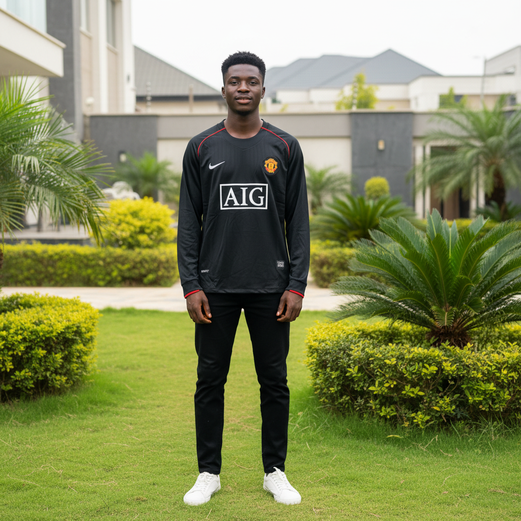 Black long-sleeve retro football jersey with red piping and AIG sponsor — Nigerian male model front view