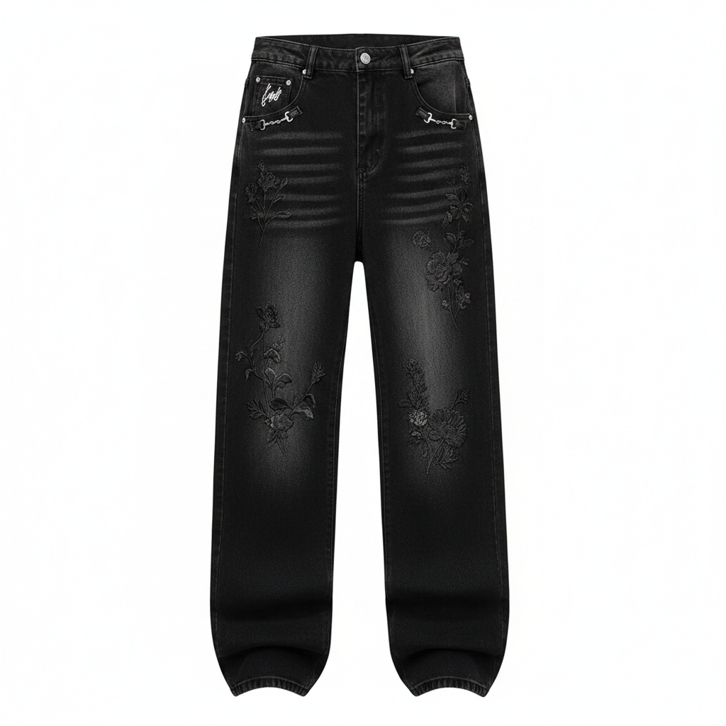 Men's black washed wide-leg baggy denim jeans with tonal floral embroidery and white script pocket detail, ghost mannequin front view