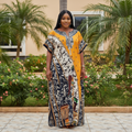 Nigerian female model wearing mustard and print panel bubu kaftan dress in garden setting