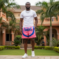 Nigerian male model wearing pink graphic shorts outdoors