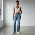 Nigerian female model wearing light blue bell-bottom flare jeans front view